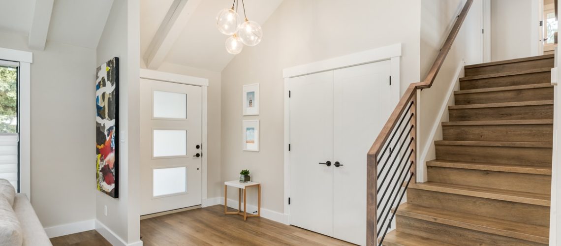 newly renovated entryway with hardwood floors and stairs